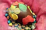 Marzipan flowers and butterflies on a chocolate egg