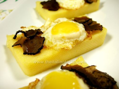 Polenta slices with quail eggs and black truffle