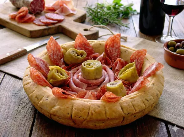 A bread bowl with salami & prosciutto